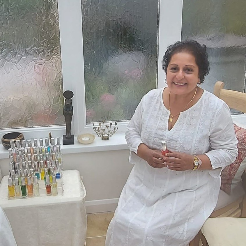 Alka Shaanthi Dharam holding a Colour Mirrors bottle beside her collection